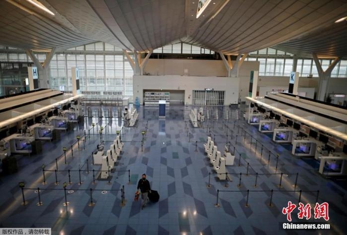 資料圖：日本東京，東京國際機場，一名乘客在國際航班航站樓的登機區(qū)。