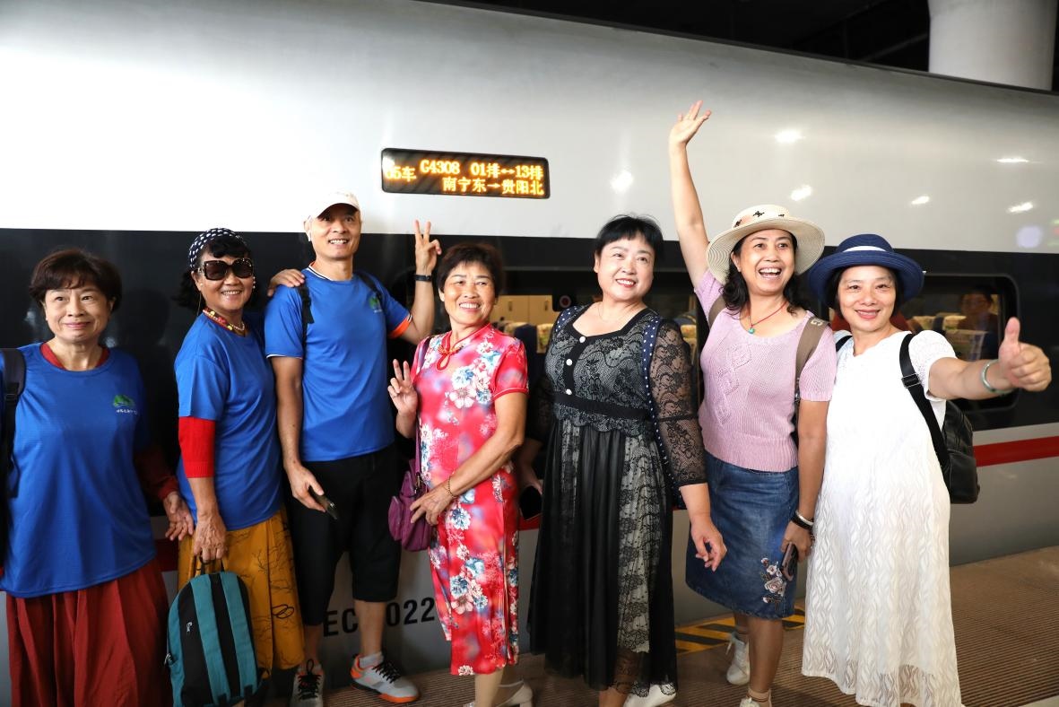 在南寧東站，旅客與貴南高鐵首發(fā)列車合影。 林祥云攝