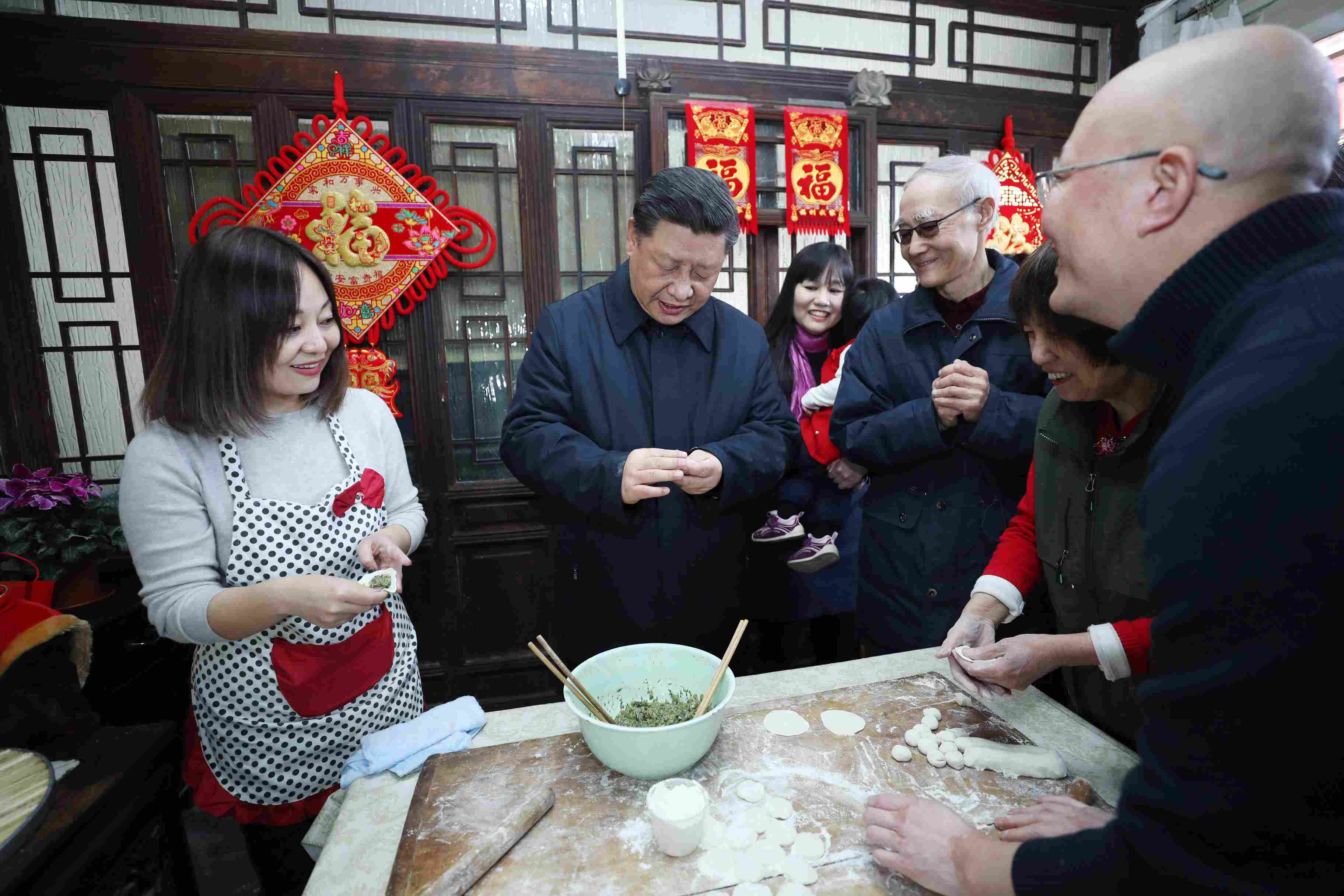 △ 2019年2月1日，習近平總書記在北京前門東區(qū)草廠四條胡同，同朱茂錦一家人包餃子、聊家常。