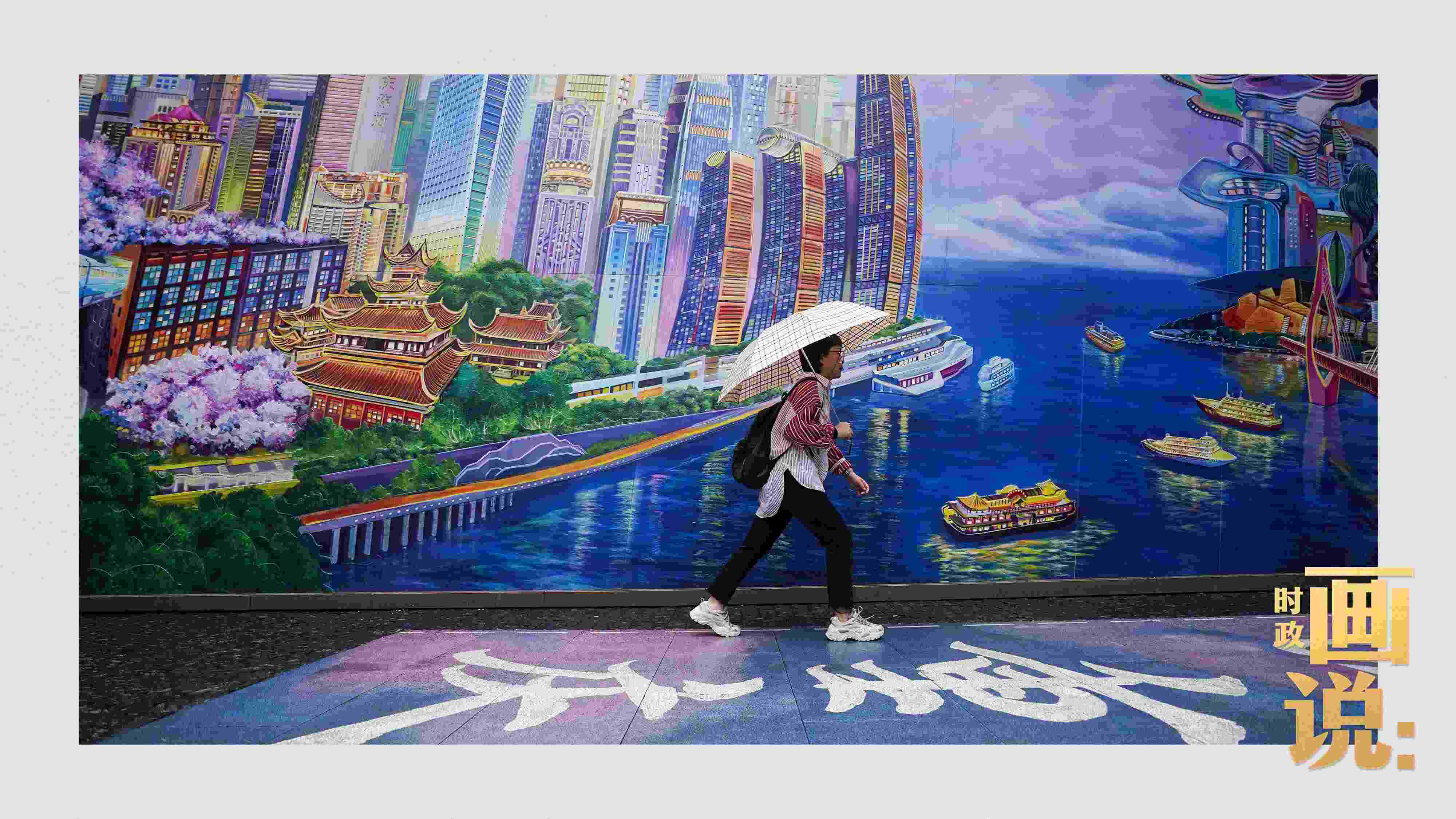 △小雨中，行人走過(guò)“重慶畫(huà)卷”主題壁畫(huà)。
