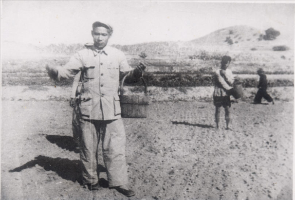 谷文昌（左）在田間與農(nóng)民一起勞動(dòng)（資料照片）。