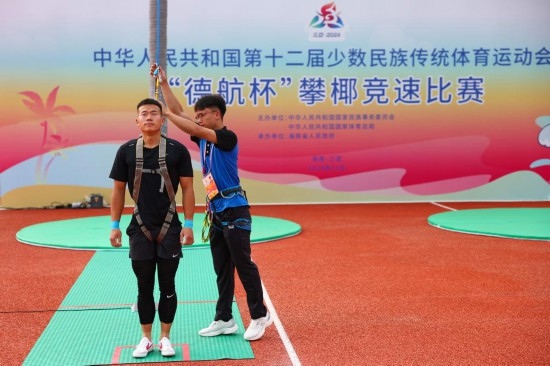 11月23日，工作人員為上海隊(duì)選手付樂樂（左）系安全繩。新華社記者 楊植森 攝