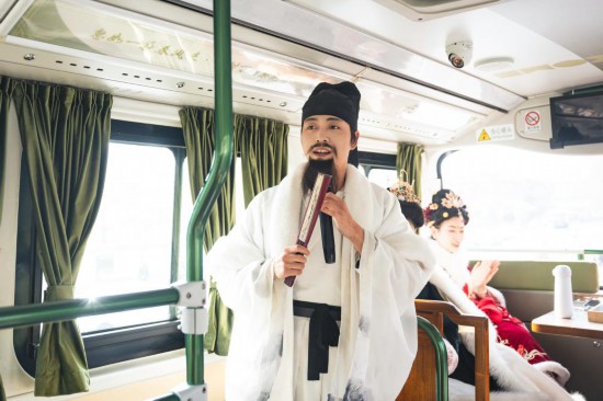 身著古裝的“伴游”在“長安尋夢”主題觀光車上為游客講解。（受訪者供圖）